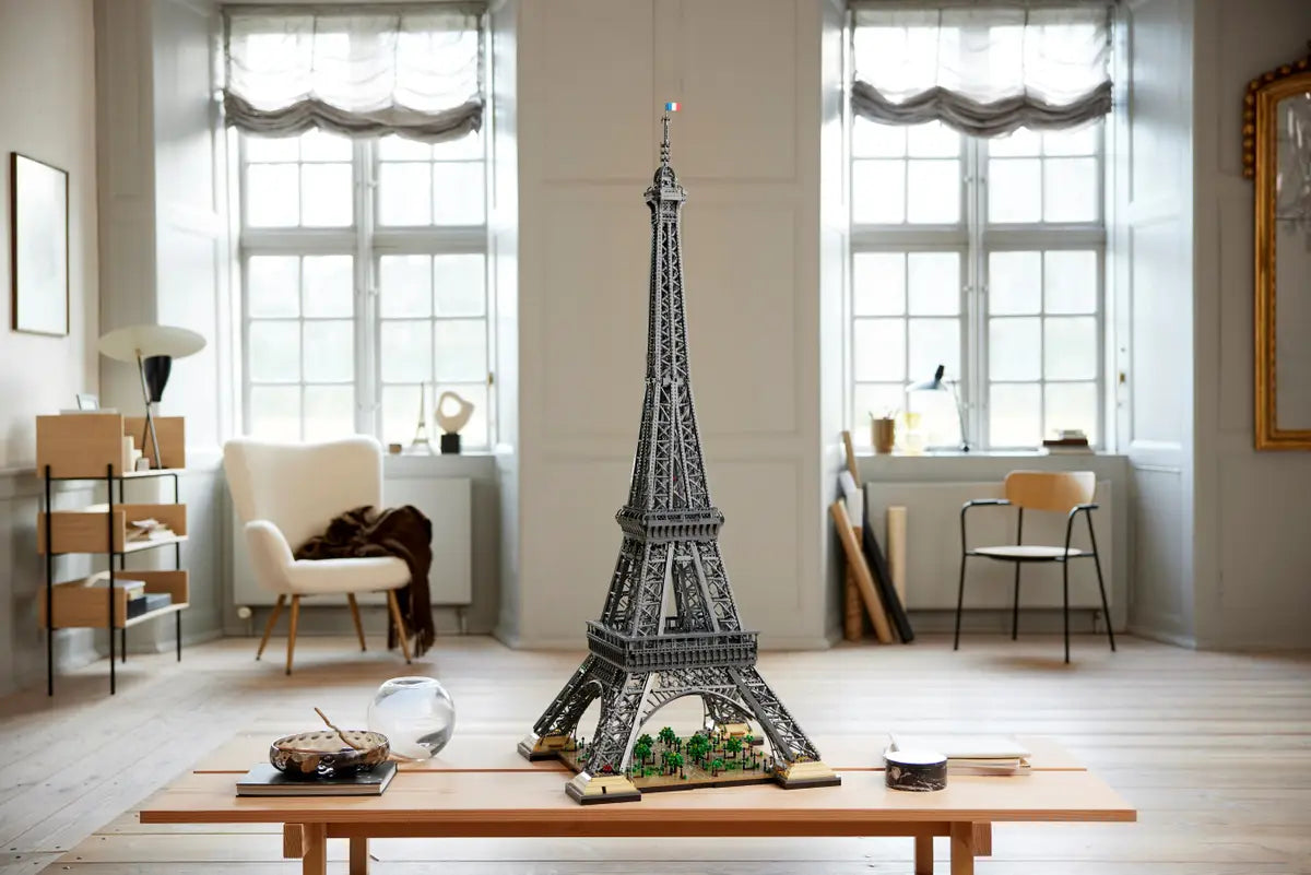Huge LEGO Eiffel Tower displayed in living room next to sofa