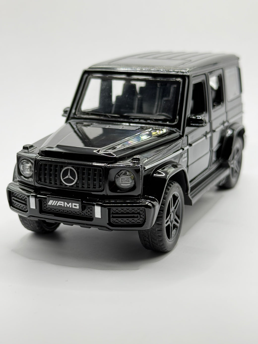 Front three-quarter view of black 1:32 scale Mercedes-Benz G63 AMG diecast model.