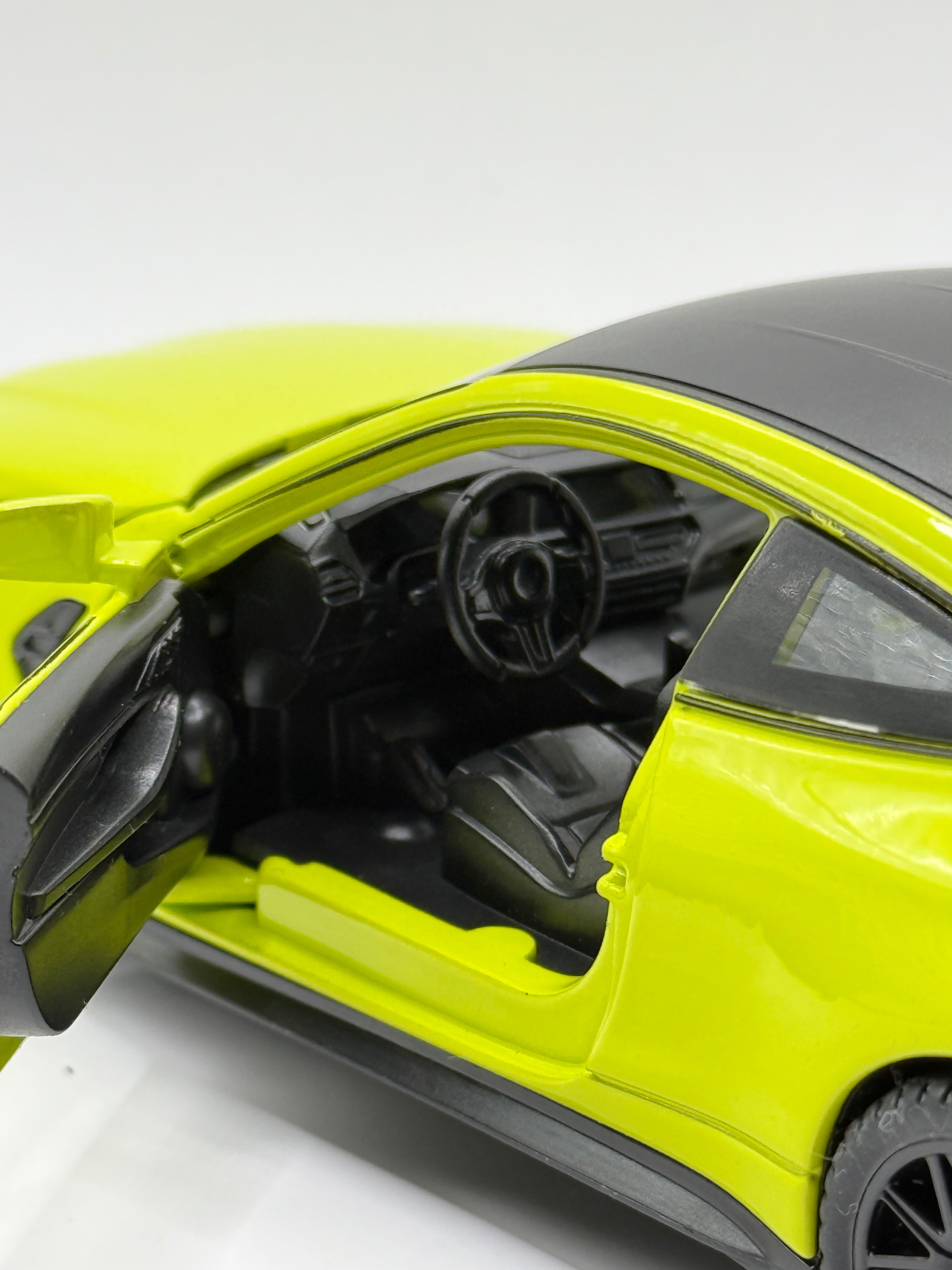 Close-up of 1/32 BMW M4 diecast car with opening doors and hood, showing the detailed interior dashboard and engine bay.