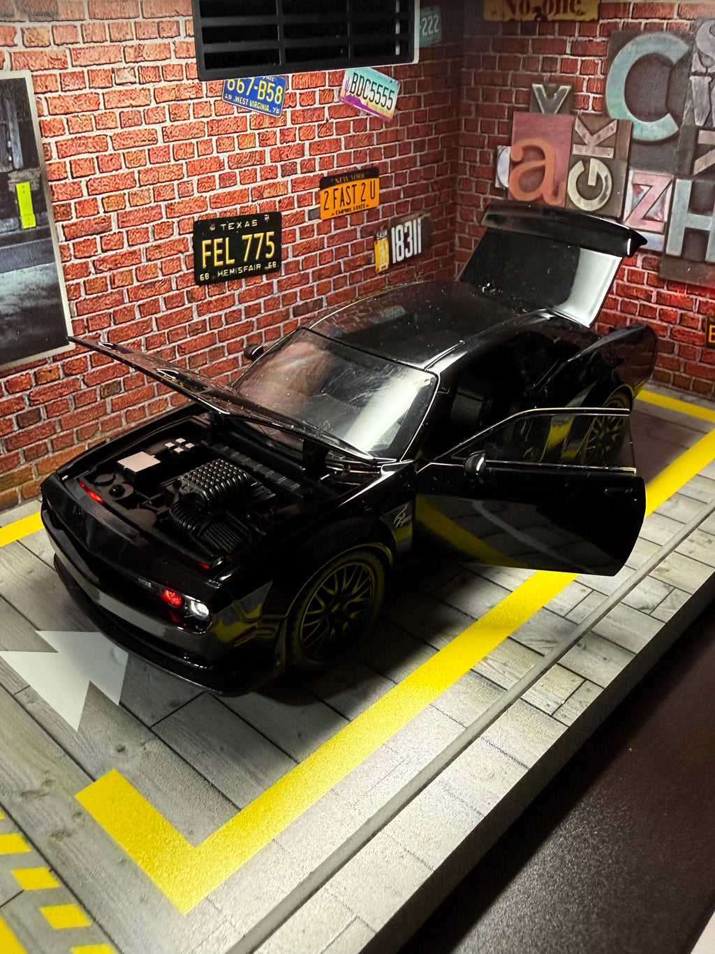 Black Dodge Challenger toy car with opening doors and hood