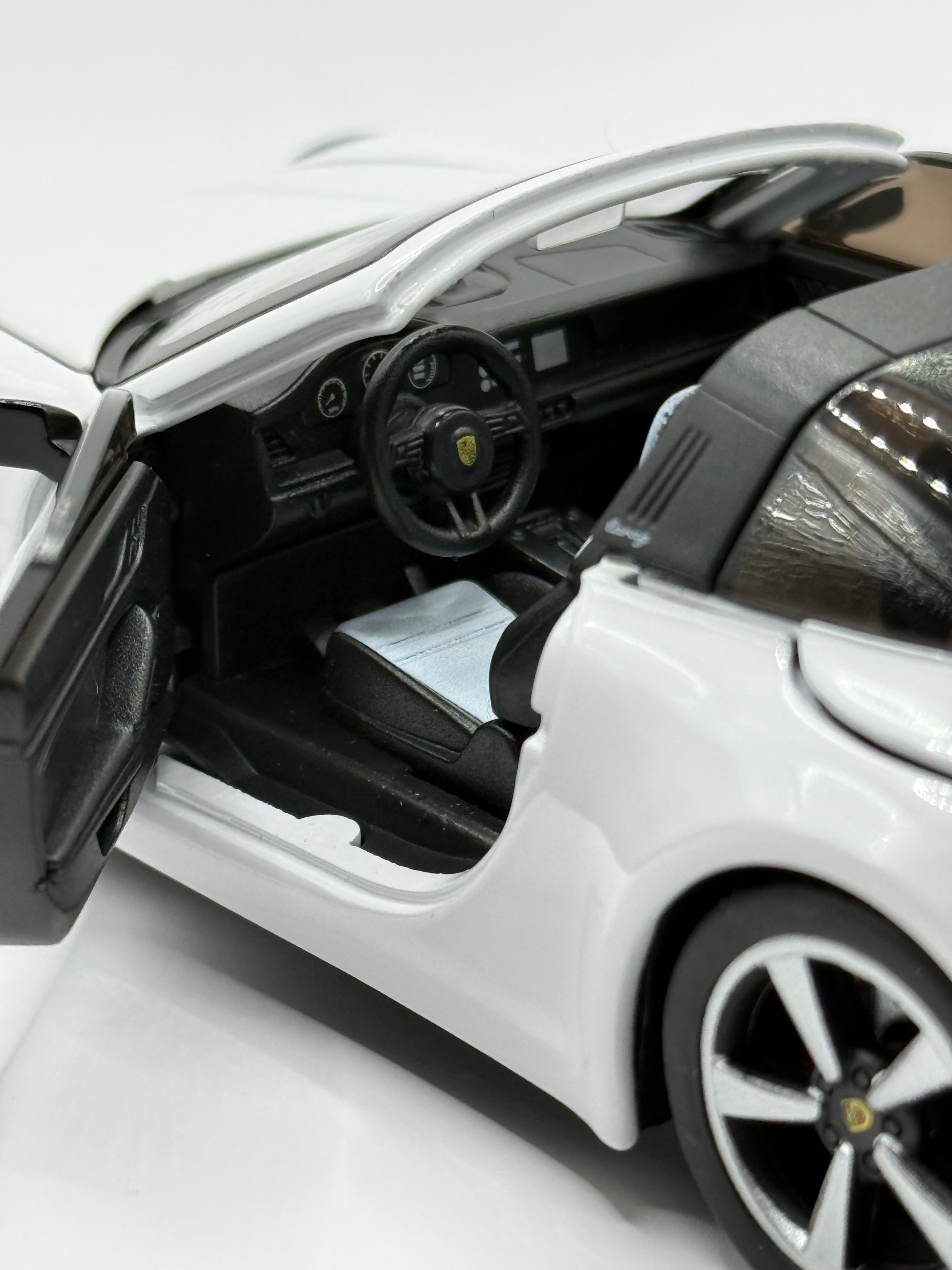 Diecast toy car with opening doors and detailed interior dashboard.
