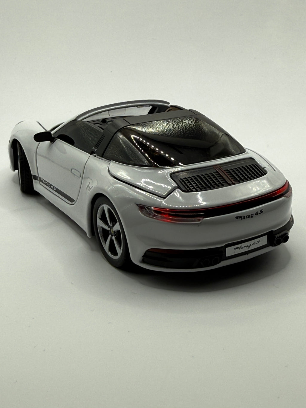 Rear of Porsche 911 model showing quad exhausts and Targa roll bar.