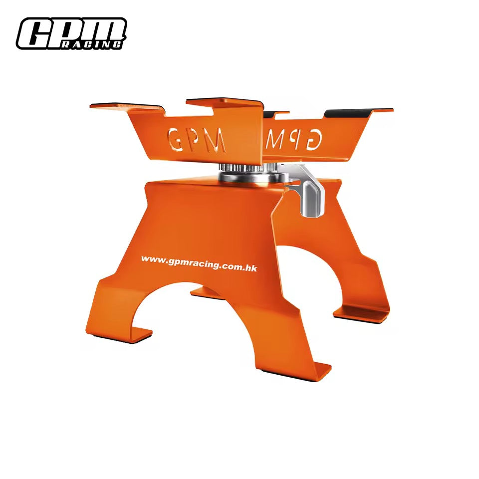 Orange GPM Racing large scale aluminium RC car stand on workbench