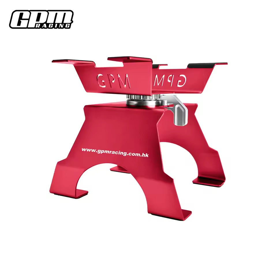 Red GPM Racing large scale aluminium RC car stand on workbench
