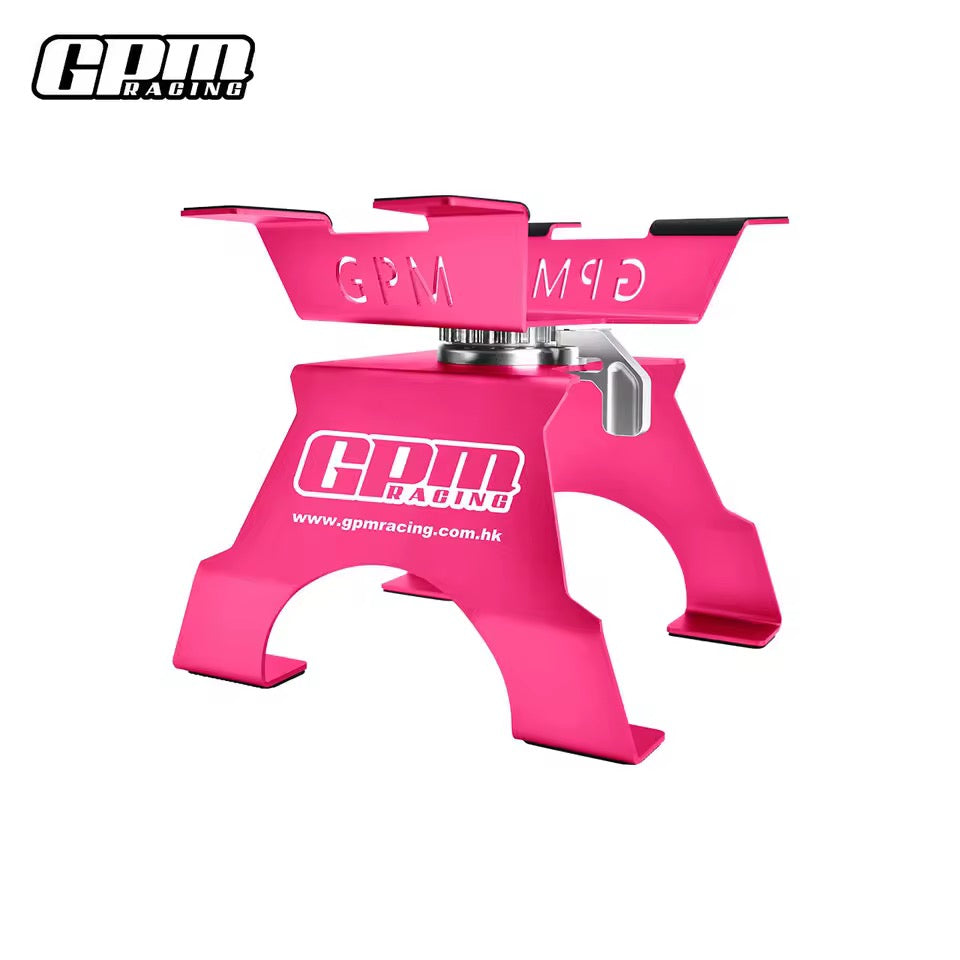 Pink GPM Racing large scale aluminium RC car stand on workbench