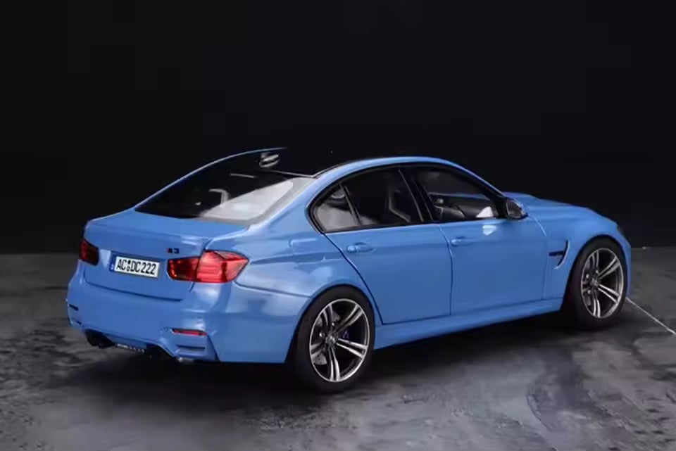 Rear view of 1:18 scale Norev BMW M3 2015 showing quad exhausts and M3 badge