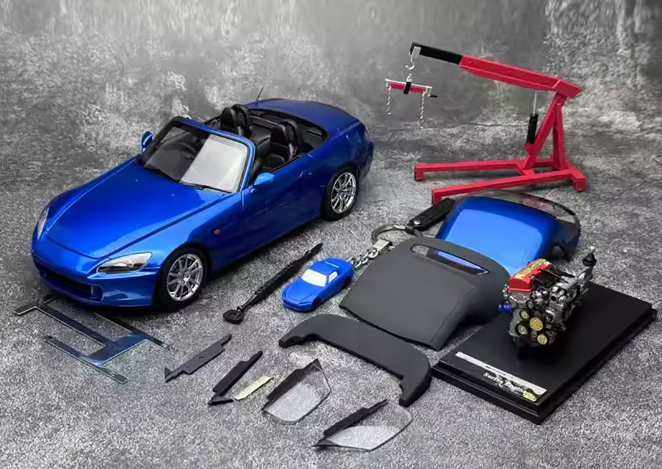 1:18 scale Motorhelix Honda S2000 AP2 resin model in Apex Blue, featuring detailed garage diorama accessories including a shop crane, engine block, and tonneau cover.