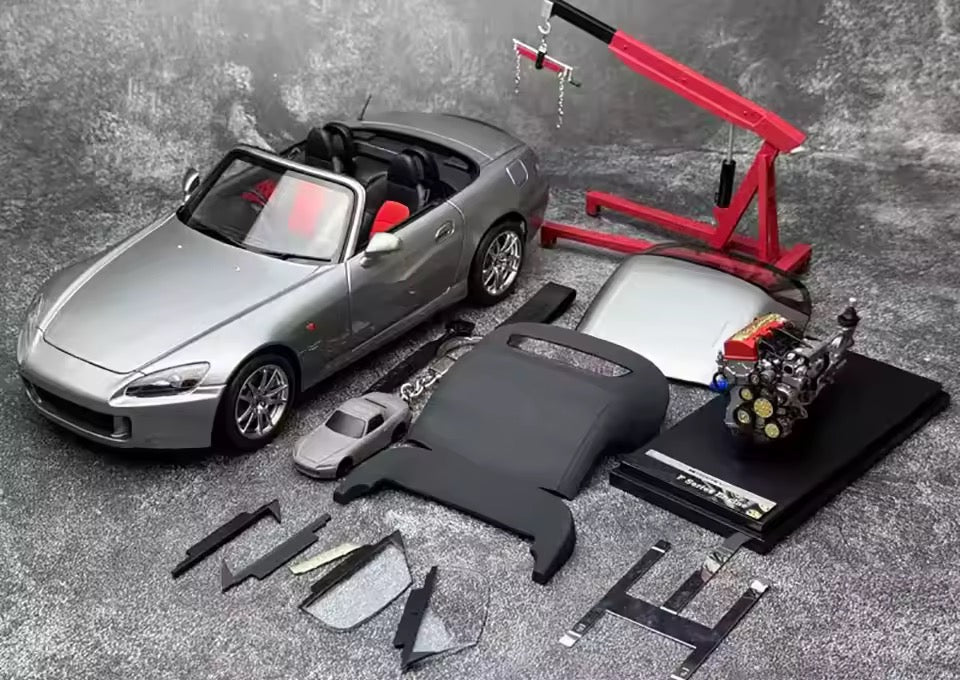 1:18 scale Motorhelix Honda S2000 AP2 diecast model in Silverstone Metallic, displayed with a removable hardtop, standalone F-Series engine replica, and a red engine hoist.